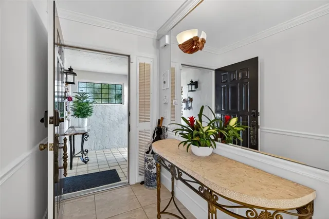 a living room with furniture a flat screen tv and a large window