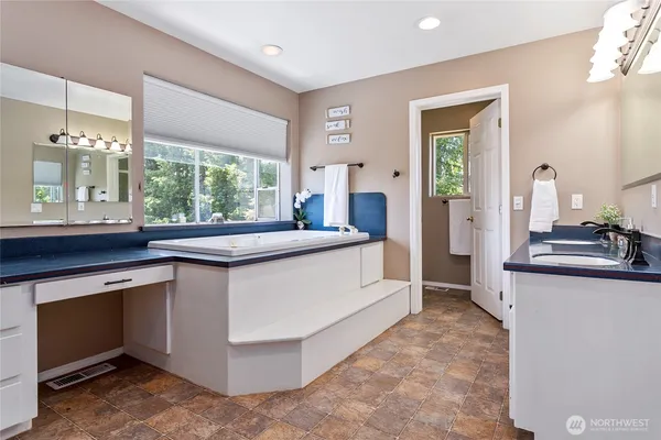 a kitchen with granite countertop a sink and cabinets