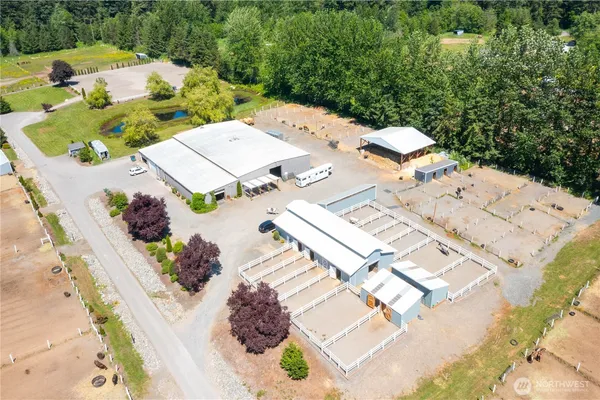 an aerial view of a house with a garden and mountain view in back