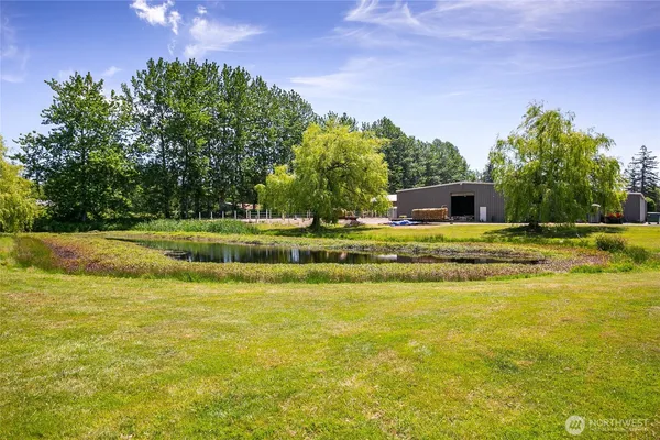 an aerial view of residential houses with outdoor space and trees
