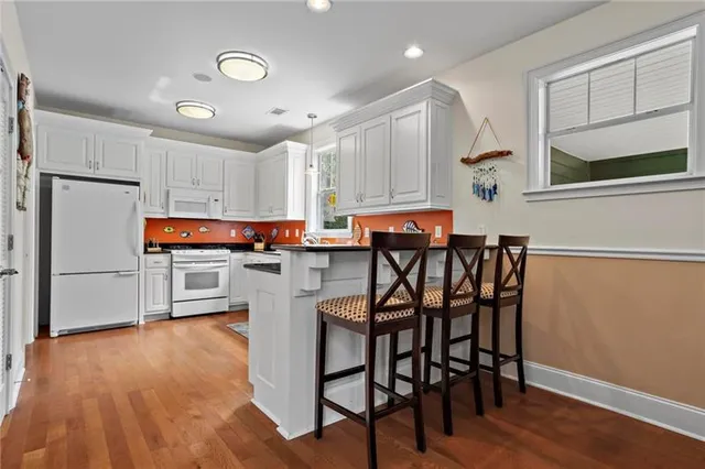 a room with furniture pool table and window
