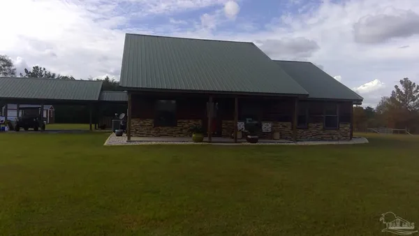 a front view of a house with swimming pool having outdoor seating