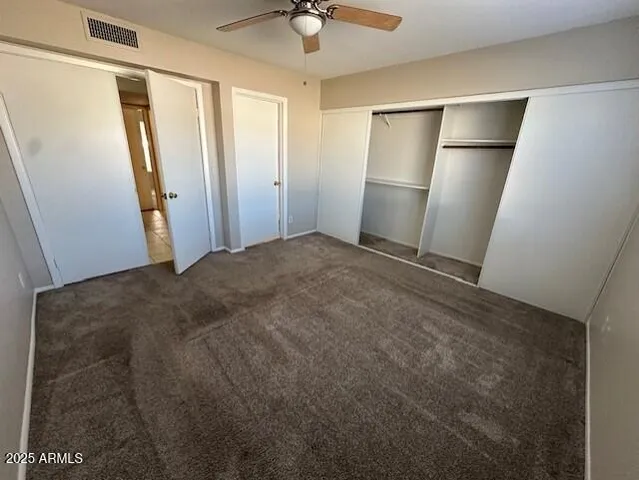a view of an empty room with a ceiling fan