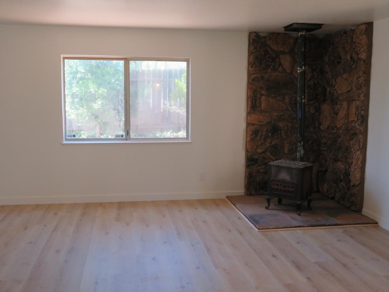 190 Bald Mountain Road West Point, CA 95255 - Photo 24 of 48 a view of an empty room with wooden floor and a window