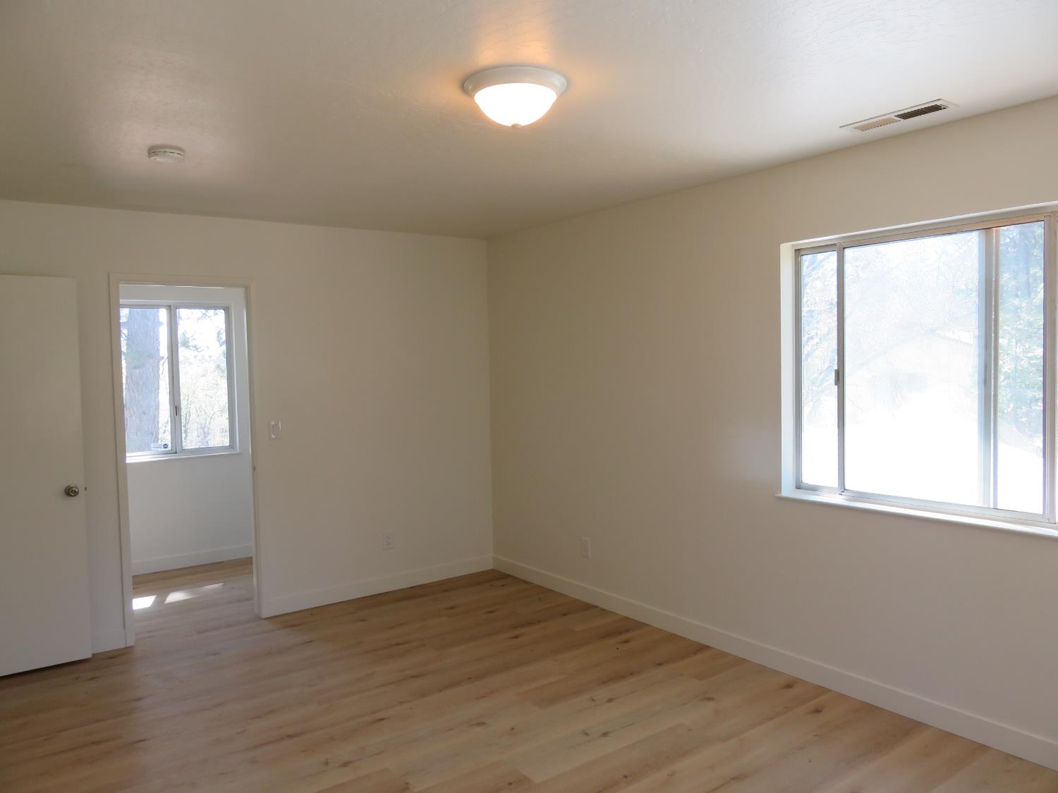 190 Bald Mountain Road West Point, CA 95255 - Photo 30 of 48 an empty room with wooden floor and windows