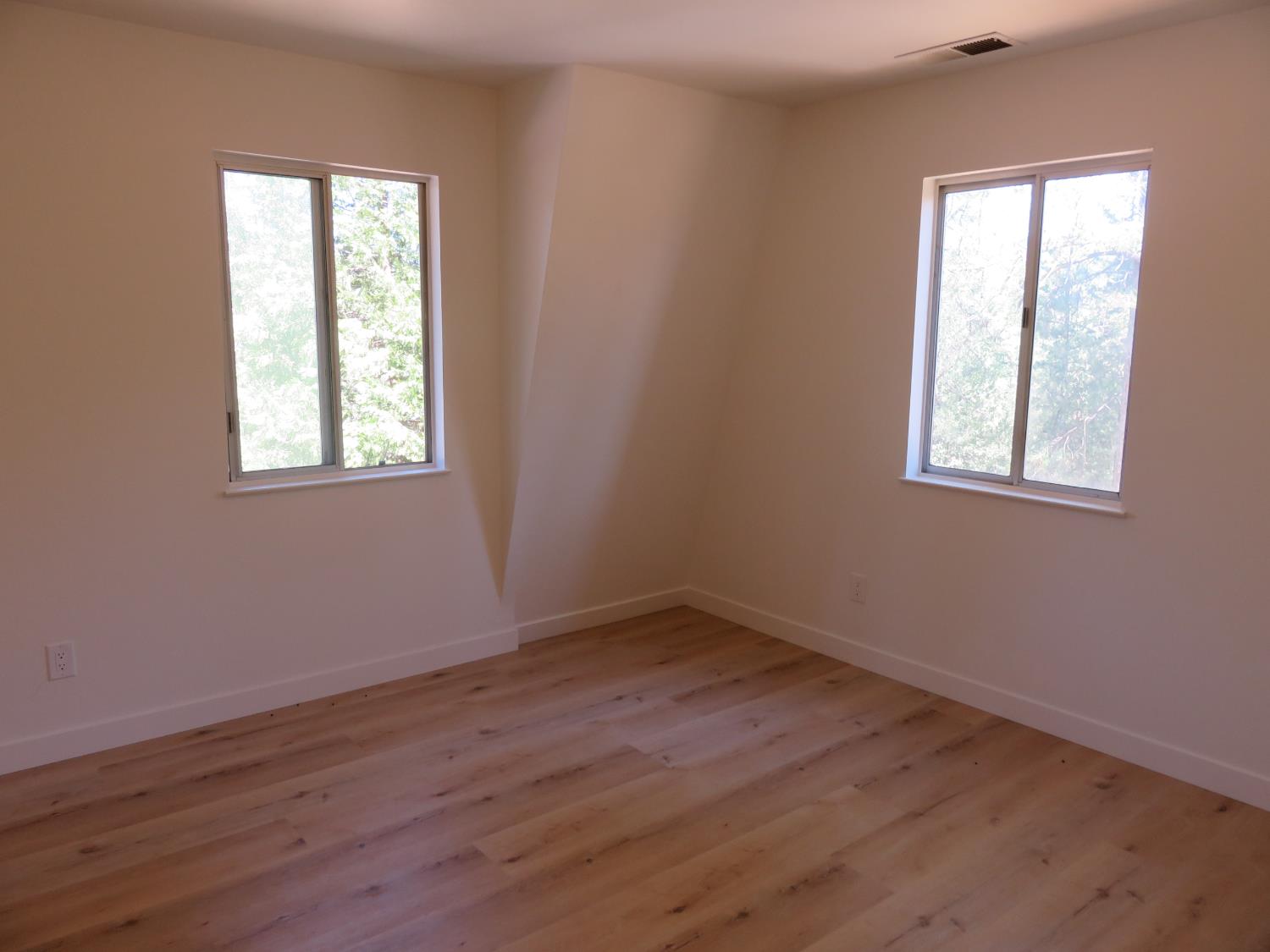 190 Bald Mountain Road West Point, CA 95255 - Photo 36 of 48 an empty room with wooden floor and windows