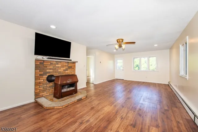 a living room with a flat screen tv and a fireplace