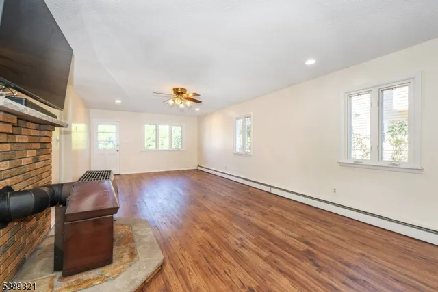 a living room with couches and painted walls with wooden floor