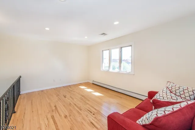 a view of a room with wooden floor and windows