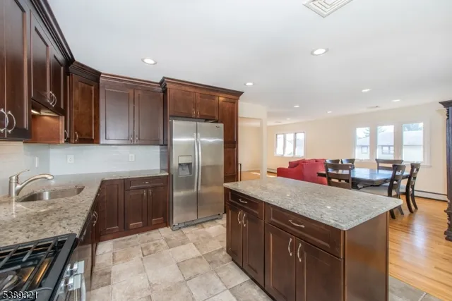 a kitchen with a stove a refrigerator and a sink