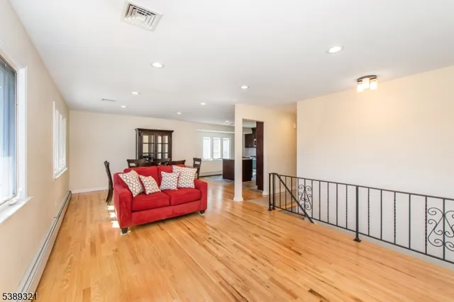a living room with furniture window and wooden floor