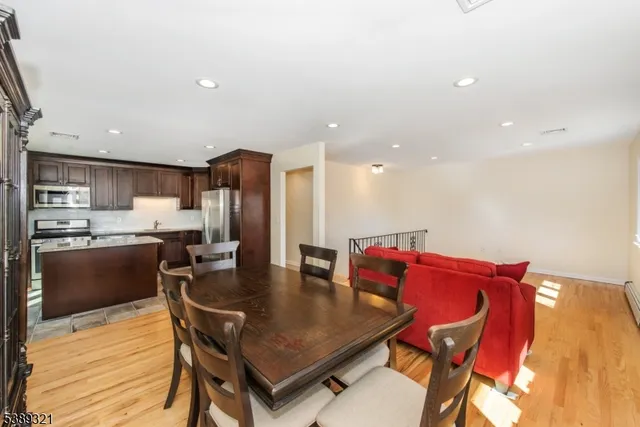 a dining room with furniture and wooden floor
