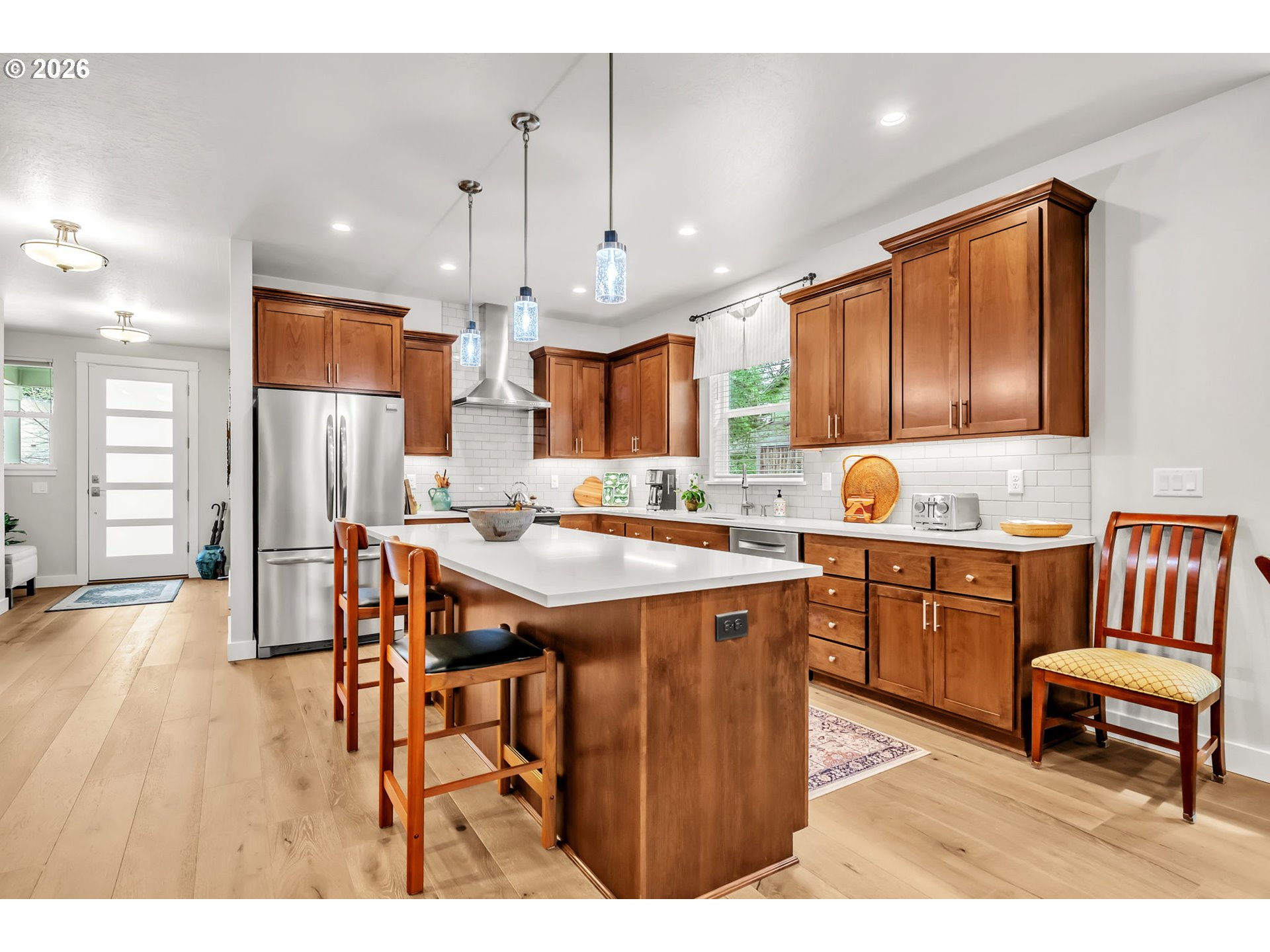 444 Emily Lane Eugene, OR 97404 - Photo 13 of 47 a kitchen with a table chairs refrigerator and cabinets