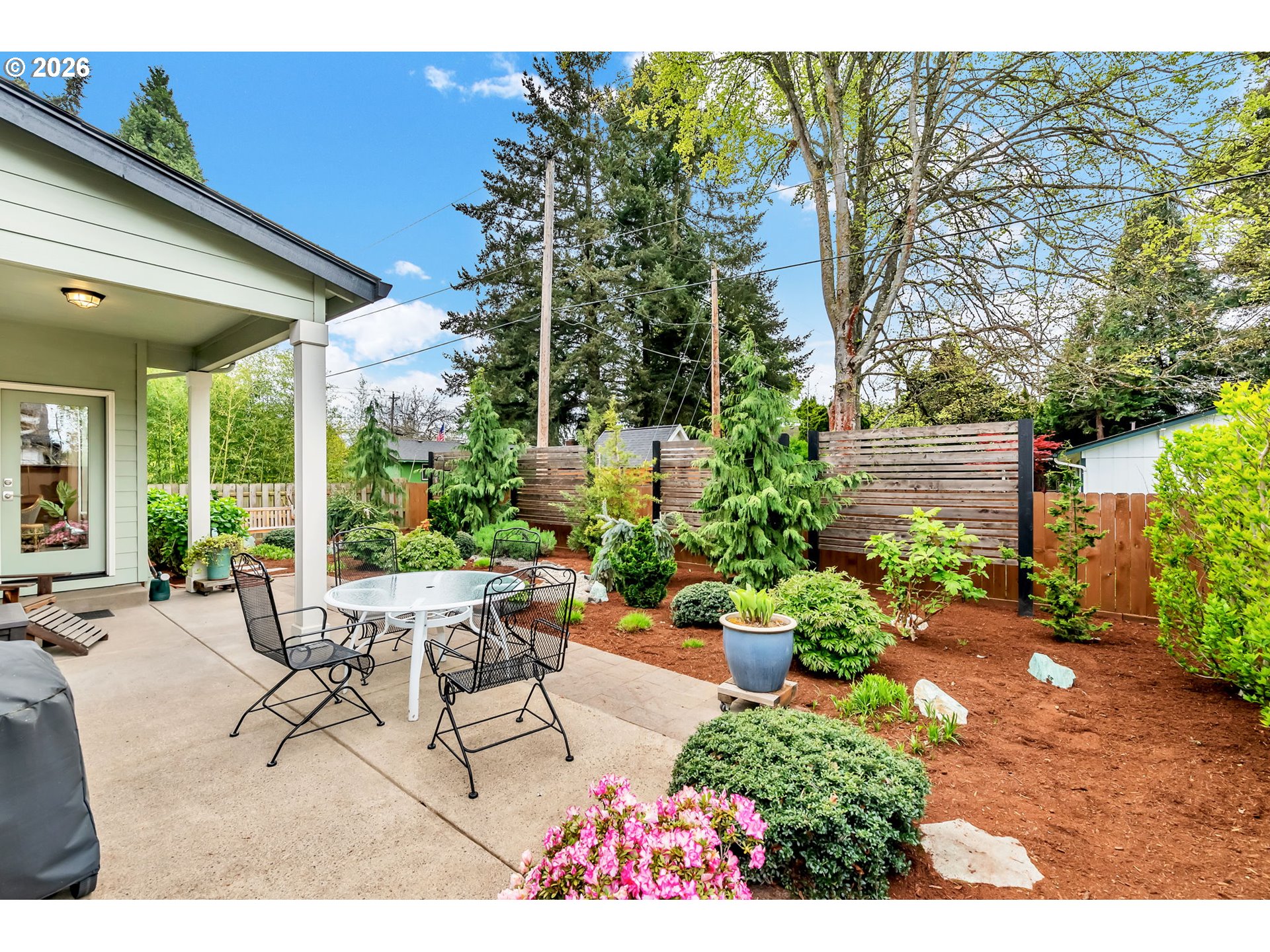 444 Emily Lane Eugene, OR 97404 - Photo 40 of 47 a view of a patio with table and chairs and potted plants