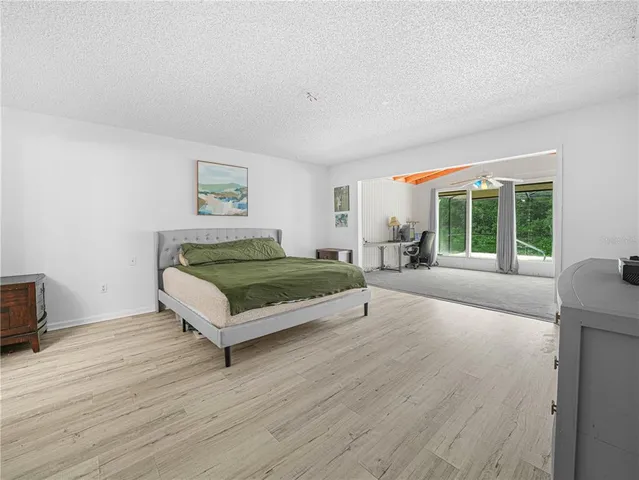 a living room with a couch wooden floor and a window