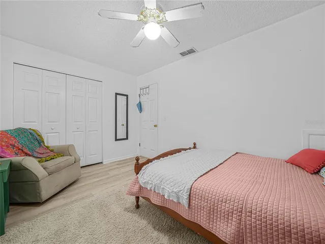 a bedroom with a bed and a couch