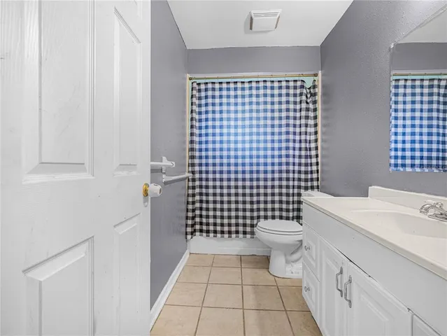 a bathroom with a sink a toilet and a shower