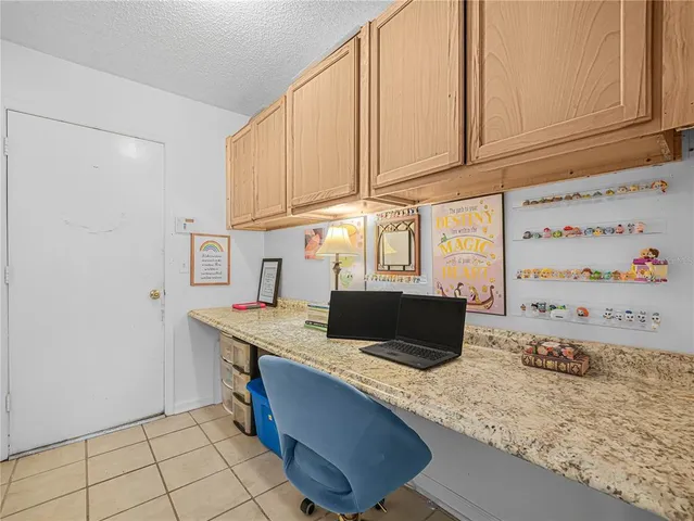 a kitchen with stainless steel appliances granite countertop a sink a stove and white cabinets