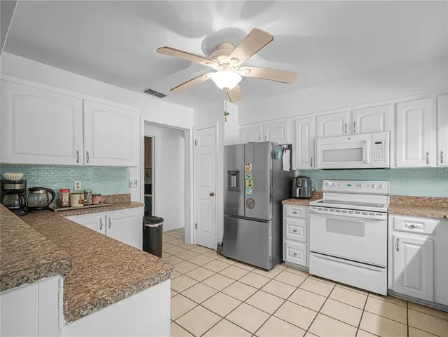 a kitchen with cabinets and stainless steel appliances