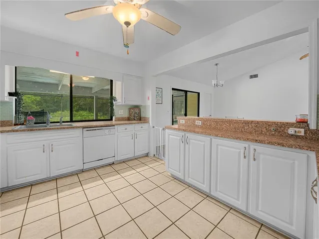 a spacious bathroom with a granite countertop sink mirror and cabinets