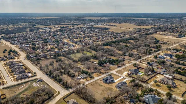a sign board with buildings in the background