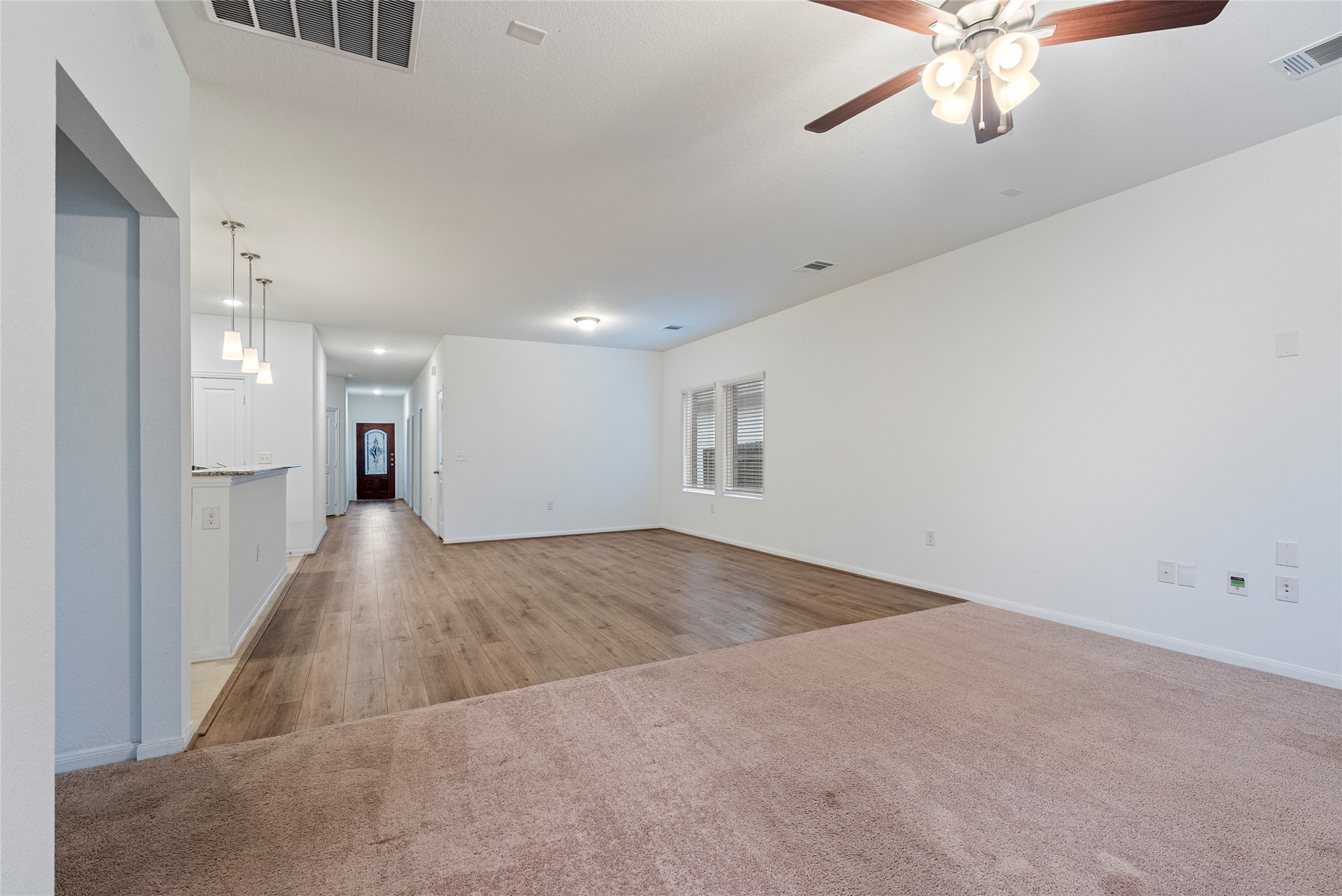 149 Biscayne Drive Kyle, TX 78640 - Photo 3 of 20 a view of a hallway with a chandelier