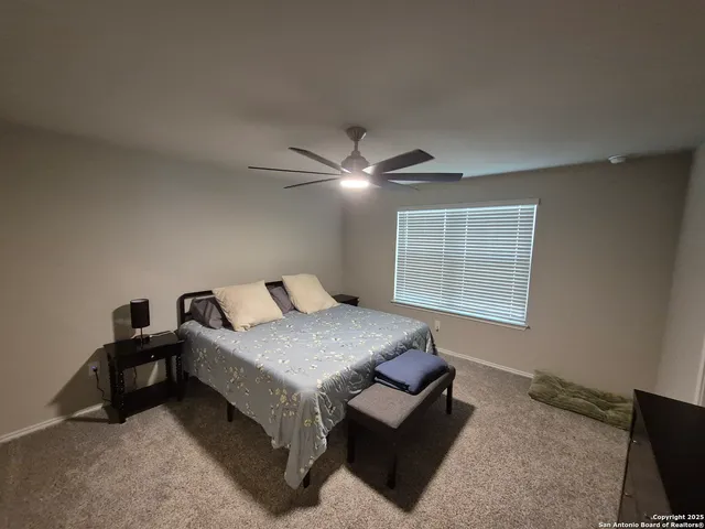 a bedroom with furniture and a window