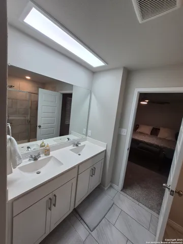 a bathroom with a double vanity sink and mirror