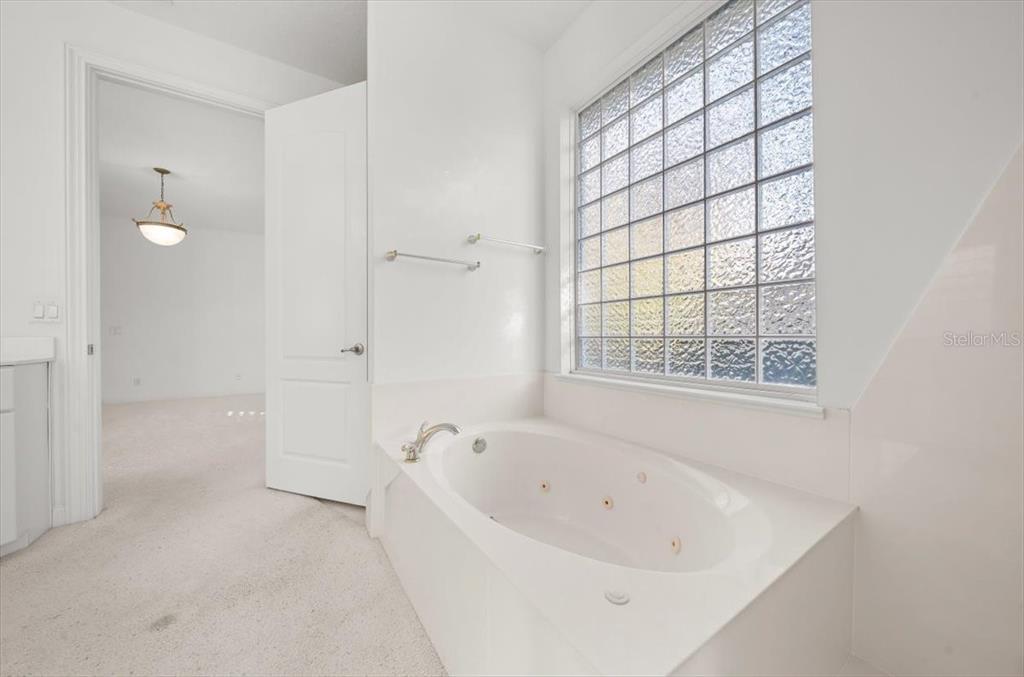 4929 Southwest 2nd Court Ocala, FL 34471 - Photo 25 of 60 a white bath tub sitting next to a window