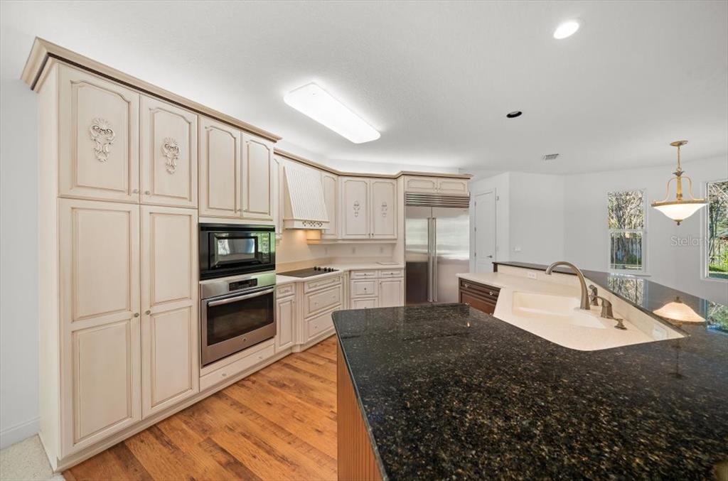 4929 Southwest 2nd Court Ocala, FL 34471 - Photo 9 of 60 a kitchen with stainless steel appliances granite countertop a refrigerator sink and stove