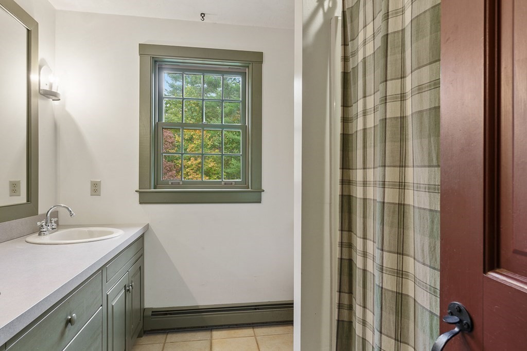 88 Bullard Road Princeton, MA 01541 - Photo 24 of 41 a bathroom with a sink a mirror and a shower