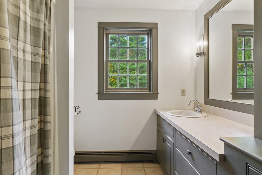 88 Bullard Road Princeton, MA 01541 - Photo 29 of 41 a bathroom with a sink a vanity and a mirror