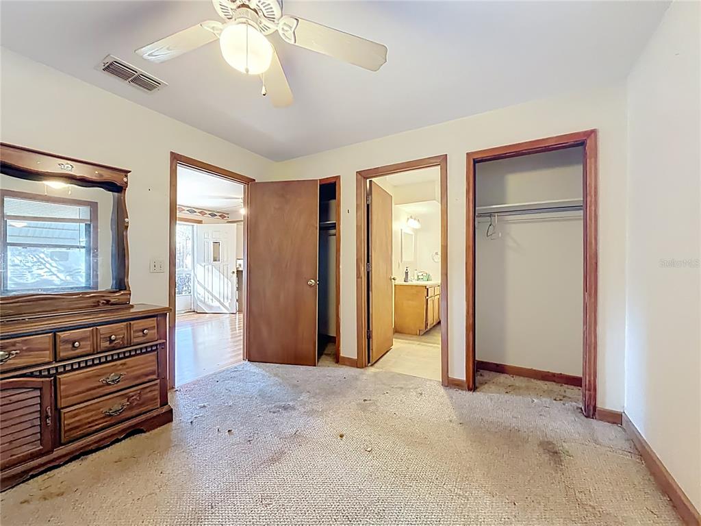 3175 Southwest 181st Court Dunnellon, FL 34432 - Photo 12 of 35 a view of a livingroom with a chandelier fan and windows