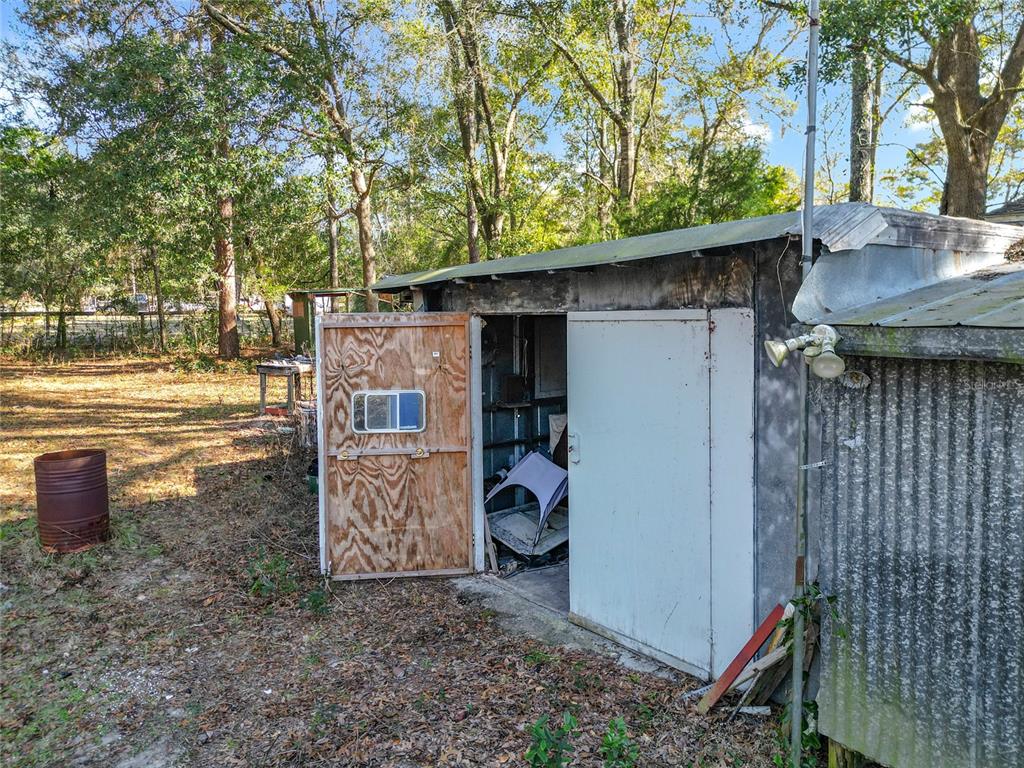3175 Southwest 181st Court Dunnellon, FL 34432 - Photo 24 of 35 a backyard of a house with barbeque oven fire pit table and chairs