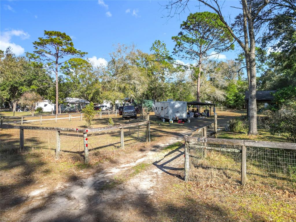 3175 Southwest 181st Court Dunnellon, FL 34432 - Photo 25 of 35 a view of a swimming pool with a bench and trees around