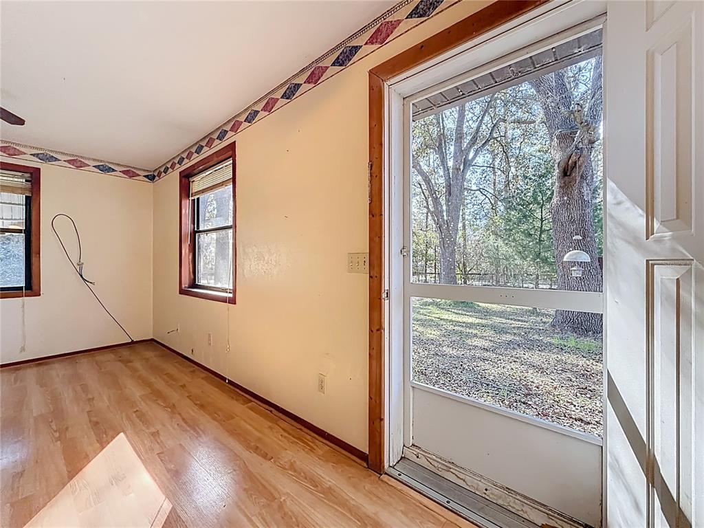 3175 Southwest 181st Court Dunnellon, FL 34432 - Photo 5 of 35 a view of a room with wooden floor and windows