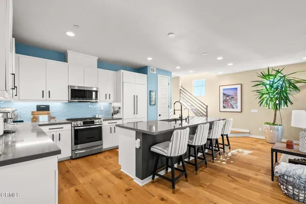 a large kitchen with a table and chairs in it