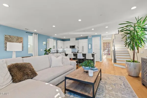a living room with furniture potted plant and a table