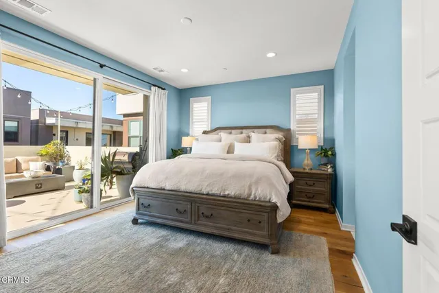 a spacious bedroom with a large bed and a large window