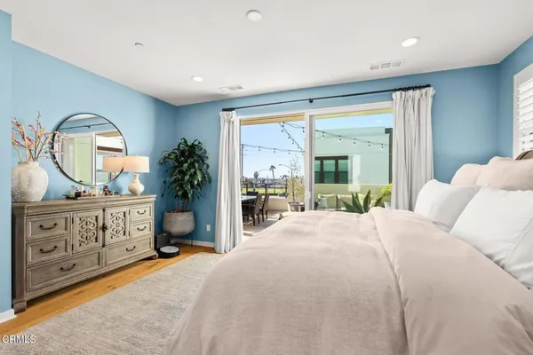 a bedroom with a large bed and a dresser