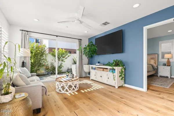 a living room with furniture windows and a flat screen tv