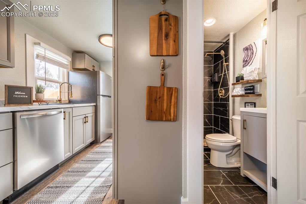 627 Alexander Road Colorado Springs, CO 80909 - Photo 15 of 40 a bathroom with a sink and a toilet