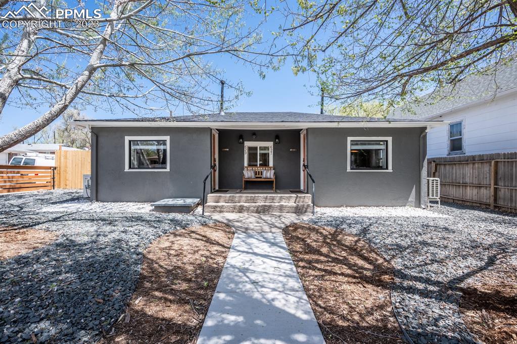 627 Alexander Road Colorado Springs, CO 80909 - Photo 2 of 40 a front view of a house with a yard and garage