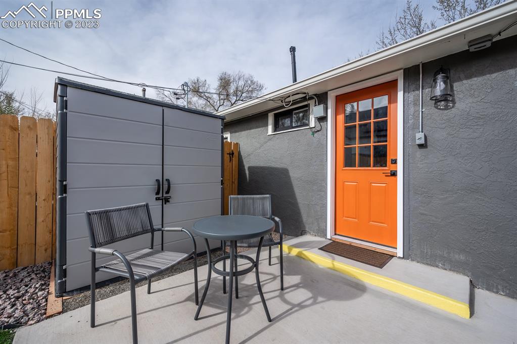 627 Alexander Road Colorado Springs, CO 80909 - Photo 21 of 40 a backyard of a house with table and chairs