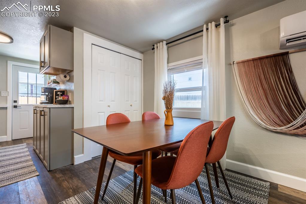 627 Alexander Road Colorado Springs, CO 80909 - Photo 28 of 40 a view of a dining room with furniture and a window