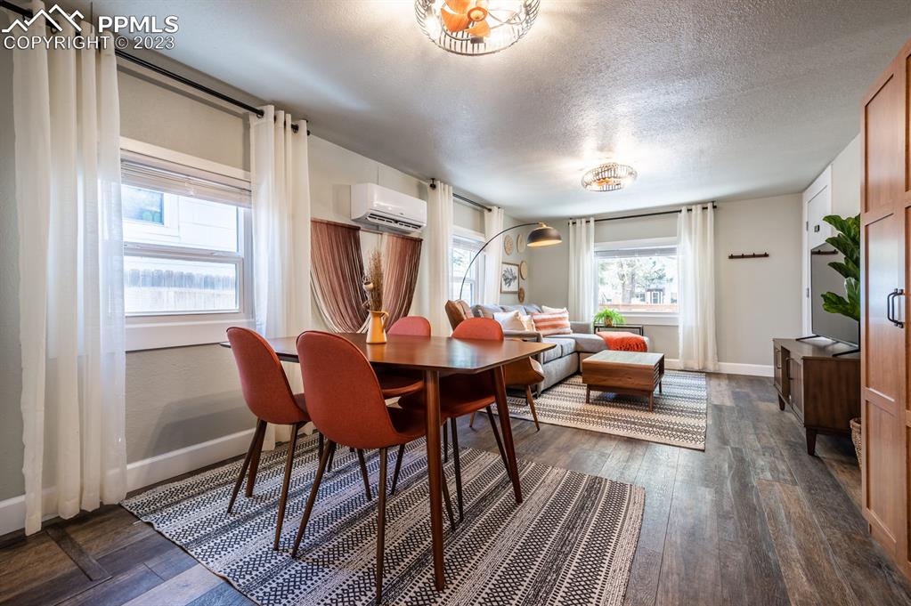 627 Alexander Road Colorado Springs, CO 80909 - Photo 29 of 40 a view of a dining room with furniture window and wooden floor