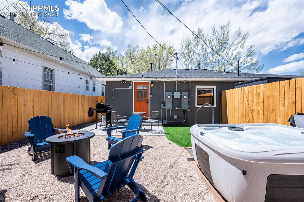 627 Alexander Road Colorado Springs, CO 80909 - Photo 40 of 40 a view of a patio with table and chairs a barbeque with wooden fence