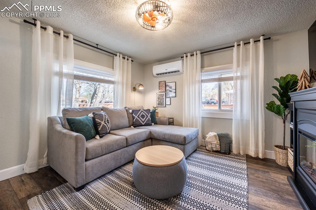 627 Alexander Road Colorado Springs, CO 80909 - Photo 4 of 40 a living room with furniture and a potted plant