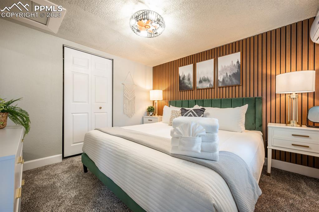 627 Alexander Road Colorado Springs, CO 80909 - Photo 8 of 40 a bed room with a bed and a potted plant