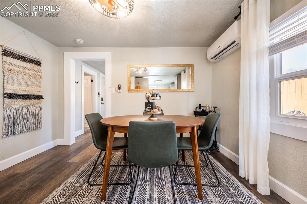627 Alexander Road Colorado Springs, CO 80909 - Photo 10 of 40 a view of a dining room with furniture window and wooden floor